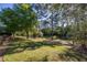 Spacious backyard with mature trees offering shade and privacy at 14809 Tudor Chase Dr, Tampa, FL 33626