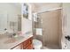 Bathroom featuring a sink, granite countertop, framed mirror, and glass enclosed tiled shower at 14809 Tudor Chase Dr, Tampa, FL 33626