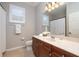 Bathroom featuring a vanity, toilet, window with shutters, and a shower with curtain at 14809 Tudor Chase Dr, Tampa, FL 33626
