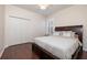 This bedroom has a ceiling fan, window with shutters, closet with folding doors, and dark hardwood floors at 14809 Tudor Chase Dr, Tampa, FL 33626