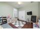 Bright room with hardwood floors, ceiling fan and a window with white shutters at 14809 Tudor Chase Dr, Tampa, FL 33626