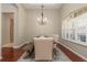 Dining room features a rustic wood table, upholstered chairs, and decorative lighting at 14809 Tudor Chase Dr, Tampa, FL 33626