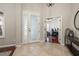 Inviting foyer with tile flooring, decorative front door, and views of the office at 14809 Tudor Chase Dr, Tampa, FL 33626