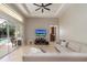 Living area with tile floors, sliding glass doors leading to the pool, and an open concept at 14809 Tudor Chase Dr, Tampa, FL 33626