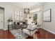 Inviting living room featuring hardwood floors, modern furnishings, and sliding doors to outdoor living space at 14809 Tudor Chase Dr, Tampa, FL 33626