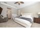 Spacious main bedroom featuring a ceiling fan, tray ceiling, neutral walls, and connecting door at 14809 Tudor Chase Dr, Tampa, FL 33626