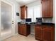 Office nook featuring built-in cabinets, a worktop, and a glass exterior door at 14809 Tudor Chase Dr, Tampa, FL 33626