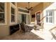 Covered patio with a ceiling fan, outdoor furniture and a TV at 14809 Tudor Chase Dr, Tampa, FL 33626