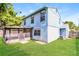 Backyard with well-maintained lawn, screened-in patio, and mature trees at 16012 Ballica Dr, Tampa, FL 33618
