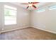 Cozy carpeted bedroom with a ceiling fan and natural light from the large window at 16012 Ballica Dr, Tampa, FL 33618