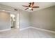 Neutral bedroom featuring tile floors and a ceiling fan at 16012 Ballica Dr, Tampa, FL 33618