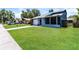 Single-story home with a well-manicured lawn, attached garage, and screened porch at 16012 Ballica Dr, Tampa, FL 33618