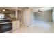 Open kitchen with stainless steel appliances and granite countertops flowing into the living room at 16012 Ballica Dr, Tampa, FL 33618
