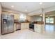 Bright kitchen with stainless steel appliances, granite counters, and access to the living room at 16012 Ballica Dr, Tampa, FL 33618