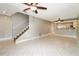 Bright living room boasts tile flooring, a ceiling fan, and staircase at 16012 Ballica Dr, Tampa, FL 33618