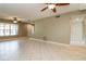 Spacious living room featuring neutral walls, tile flooring and ceiling fan at 16012 Ballica Dr, Tampa, FL 33618