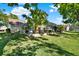 Spacious backyard featuring a screened-in patio and mature trees, perfect for outdoor entertaining at 17108 Longacres Ln, Odessa, FL 33556