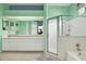 Bathroom features a double sink vanity, shower with glass door, and separate tub at 17108 Longacres Ln, Odessa, FL 33556