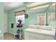 Bright bathroom with a white vanity, large mirror, and a window dressed with a floral valance at 17108 Longacres Ln, Odessa, FL 33556