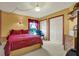 Comfortable bedroom featuring a queen bed, matching nightstands, and a rocking chair near the window at 17108 Longacres Ln, Odessa, FL 33556