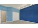 Bedroom showcasing a closet and bi-color paint scheme with light blue and dark blue at 17108 Longacres Ln, Odessa, FL 33556
