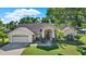 Well-maintained single-story home with manicured lawn, two car garage, and inviting front entrance at 17108 Longacres Ln, Odessa, FL 33556