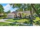 Charming single-story home with manicured lawn, mature trees, and attached two car garage at 17108 Longacres Ln, Odessa, FL 33556