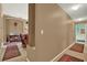 Hallway with neutral paint color with access to the living room at 17108 Longacres Ln, Odessa, FL 33556