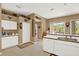 Open kitchen with white cabinets, a breakfast bar and lots of decor throughout at 17108 Longacres Ln, Odessa, FL 33556