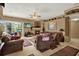 Inviting living room showcasing a fireplace, neutral walls, and comfortable seating at 17108 Longacres Ln, Odessa, FL 33556