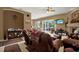 Spacious living room with sliding glass doors, neutral paint and ceiling fan at 17108 Longacres Ln, Odessa, FL 33556