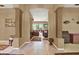 Hallway with pillars lead to a warm and inviting living room with neutral tones and a relaxing atmosphere at 17108 Longacres Ln, Odessa, FL 33556