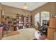 Home office space with large windows, custom built-in bookshelves, and desk at 17108 Longacres Ln, Odessa, FL 33556