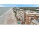 Aerial of beachfront condos overlooking sandy beach with river and neighborhood backdrop for premier views at 17940 Gulf Blvd # 2D, Redington Shores, FL 33708
