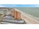 Aerial view captures beachfront condo with nearby highway, ocean, and ample parking for convenient access at 17940 Gulf Blvd # 2D, Redington Shores, FL 33708