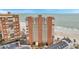 Aerial view of oceanfront condominium with pool, parking, and close beach access for relaxing coastal living at 17940 Gulf Blvd # 2D, Redington Shores, FL 33708