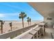 Enjoy the view from this ample balcony with high-top seating overlooking the beach with swaying palms at 17940 Gulf Blvd # 2D, Redington Shores, FL 33708
