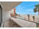 Relax on the balcony with a beachfront view overlooking a pool and furnished with a high-top table and chairs at 17940 Gulf Blvd # 2D, Redington Shores, FL 33708