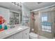 Updated bathroom with a walk-in shower, tiled floor, and ample storage space at 17940 Gulf Blvd # 2D, Redington Shores, FL 33708