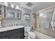 Bathroom features a vanity, shower with sliding glass doors, and beach decor at 17940 Gulf Blvd # 2D, Redington Shores, FL 33708