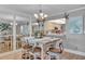 Coastal dining area boasts a chandelier, seating for six, and mirrored walls at 17940 Gulf Blvd # 2D, Redington Shores, FL 33708