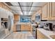 Functional kitchen with stainless steel appliances, wood cabinets, and a view to the ocean at 17940 Gulf Blvd # 2D, Redington Shores, FL 33708