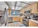 Bright kitchen with stainless steel appliances, wooden cabinetry, and ocean view at 17940 Gulf Blvd # 2D, Redington Shores, FL 33708