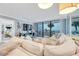 Living room includes a large sectional, ocean view, and access to the balcony at 17940 Gulf Blvd # 2D, Redington Shores, FL 33708