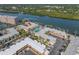 Aerial view of community featuring a pool, tennis courts, boat docks, and access to the Gulf at 19417 Gulf Blvd # B-210, Indian Shores, FL 33785