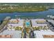 Aerial view showcasing pool and waterfront complex with dock access to water at 19417 Gulf Blvd # B-210, Indian Shores, FL 33785