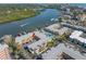 Aerial view of property showcasing the pool, parking, landscaping, and waterfront access with canal at 19417 Gulf Blvd # B-210, Indian Shores, FL 33785