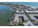 Aerial view of waterfront property with a pool and docks on canal that leads to the Gulf at 19417 Gulf Blvd # B-210, Indian Shores, FL 33785