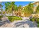 The backyard area features lush tropical landscaping, a picnic table, a grill, and gravel at 19417 Gulf Blvd # B-210, Indian Shores, FL 33785