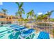 Sun deck with lounge chairs and palm trees offering a tranquil outdoor space at 19417 Gulf Blvd # B-210, Indian Shores, FL 33785